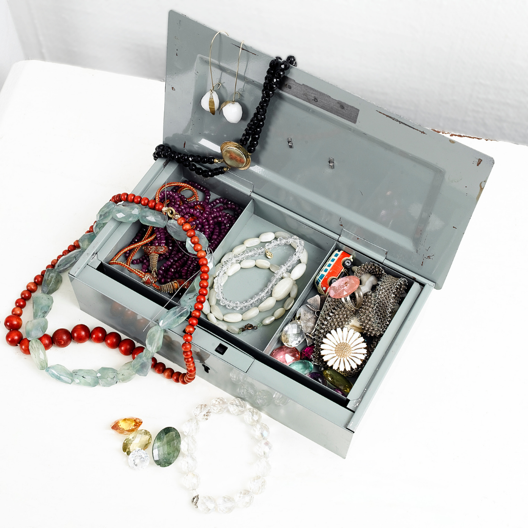 metal jewelry box filled with necklaces rings and earrings